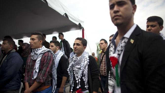 FILE - In this Nov. 6, 2014 file photo, Palestinian students attend a welcome ceremony at the Simon Bolivar airport in Maiquetia, Venezuela. The Palestinian students were greeted like celebrities upon arrival in Caracas. President Nicolas Maduro played up their symbolic importance during an address broadcast across the country. But eight months later, about a third of the Palestinians have dropped out, complaining that the program lacks academic rigor, according to interviews conducted with students, teachers and government officials. (AP Photo/Ariana Cubillos, File)